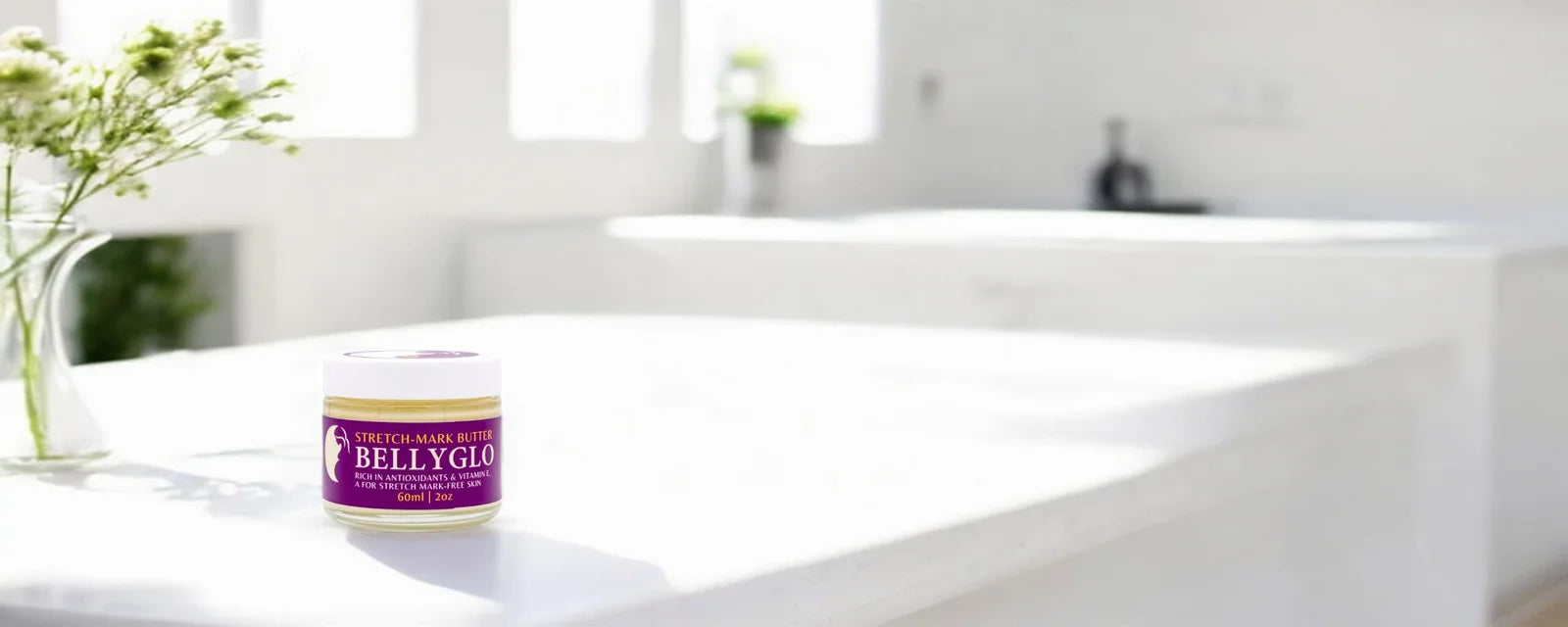 Jar of bellyglo on a white surface with a blurred background